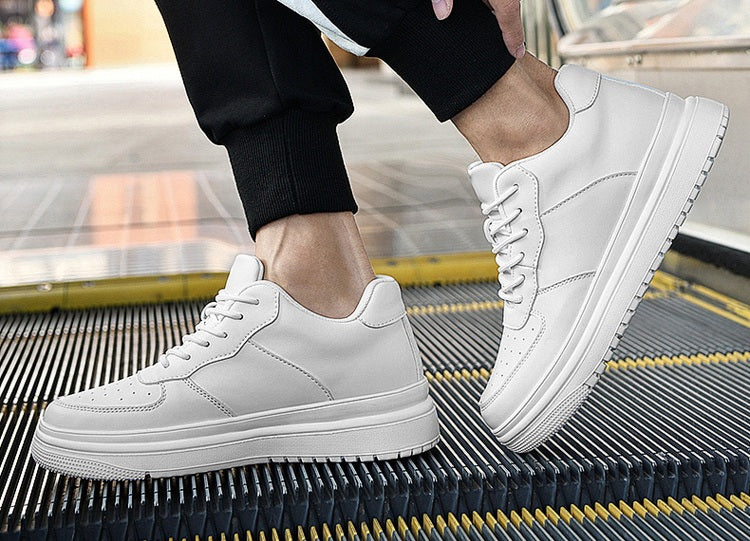 White Dayline sneakers worn on an escalator